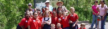 Ranger and a school group all wave at the camera at the Barataria Preserve.